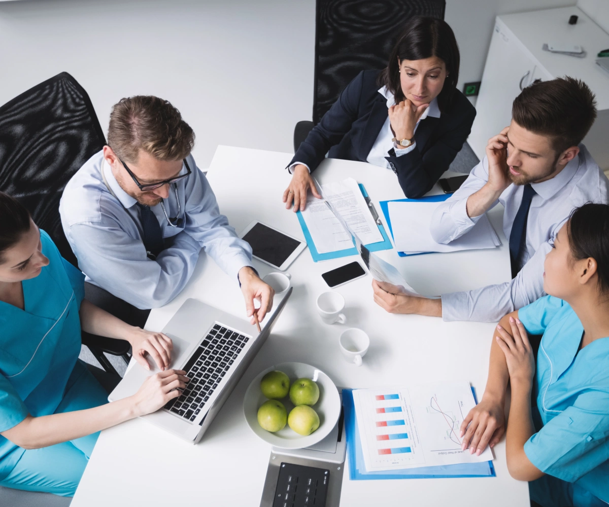 Healthcare professionals reviewing clinical and financial records